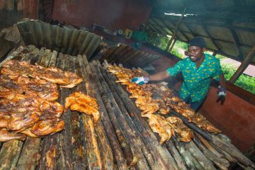 man jerking pork and chicken