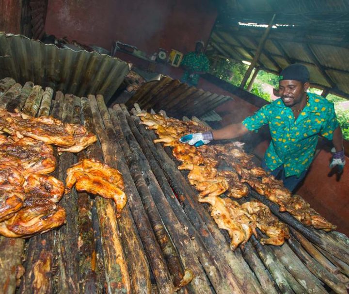 man jerking pork and chicken