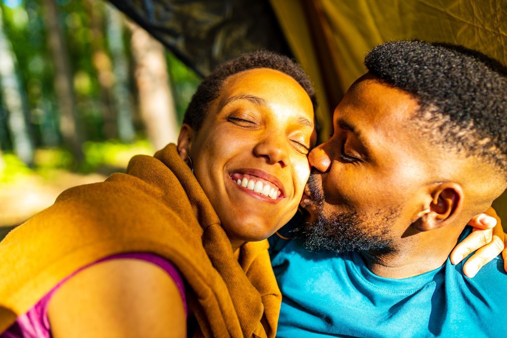 two happy African American people in love spending time outdoors.